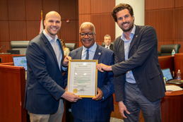 Accepting the 2026 March Florida Bicycle Month proclamation from Mayor Keith A. James, center, are, Brian Ruscher, left, and Nicholas Bixler.