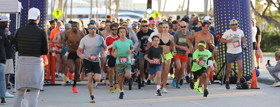 Join the West Palm Beach Police Department for the 10th Annual Run with the Cops 5K 2026 photo of people passing the finish line from last year