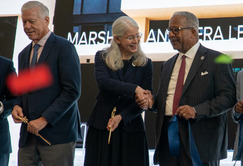 mayor shakes someone's hand on stage with confetti in the air and cut ribbon still in hand 