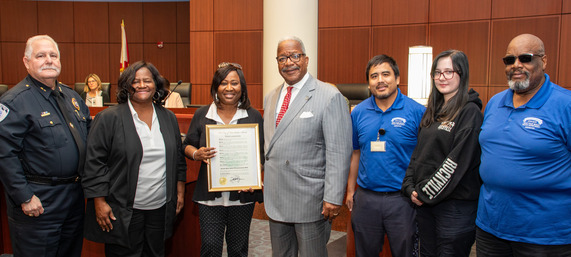 Suzette Dodd and her team accept the proclamation from Mayor Keith A. James - 1