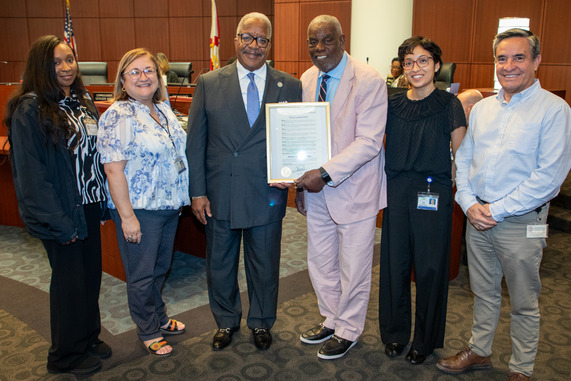 National Small Business Week photo of group of people smiling and holding the proclamation in Commission Chambers west palm beach 