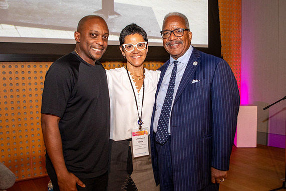  3 people smile for the camera - Hank Willis Thomas, Sybille Canthal, Mayor Keith A. James - a