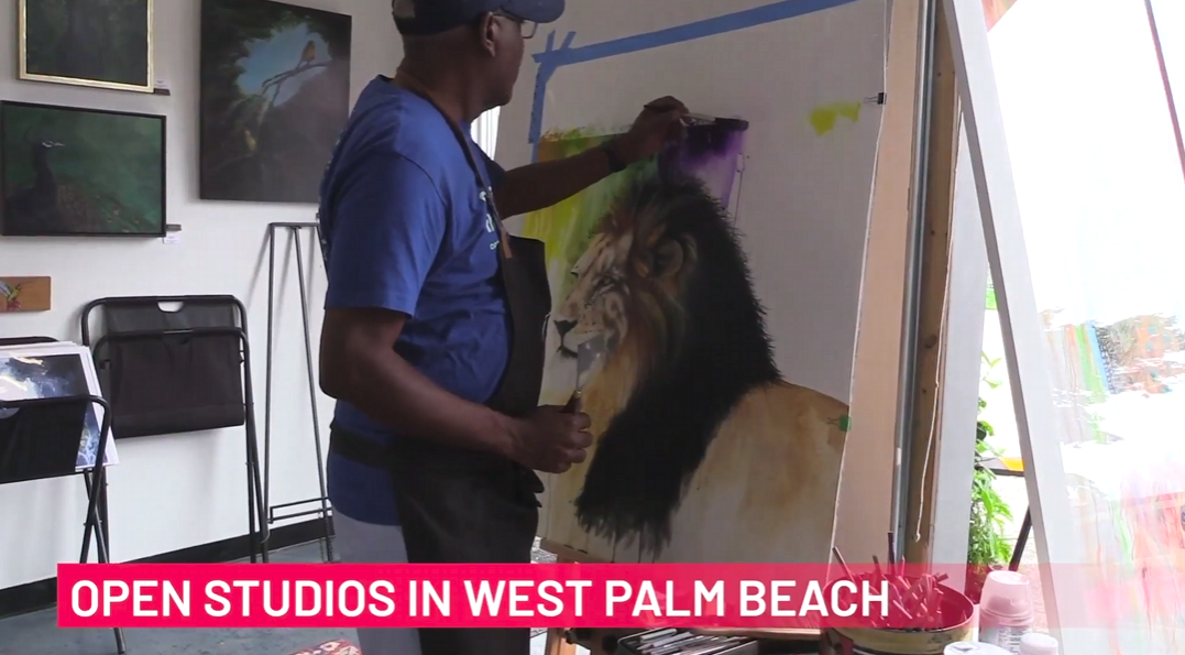 Photo of a man painting a lion on a canvas With Text that says "Open Studios in West Palm Beach"