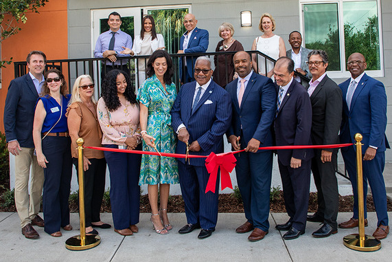 Pre-cutting pose, Mayor Keith A. James, is joined by Group of people to cut ribbon at Coleman Park