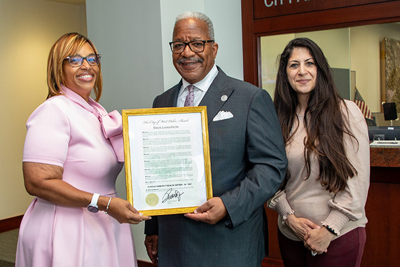 50th Anniversary Proclamation, FLORIDA COMMUNITY HEALTH CENTERS, INC. DAY -three people pose for photo with plaque