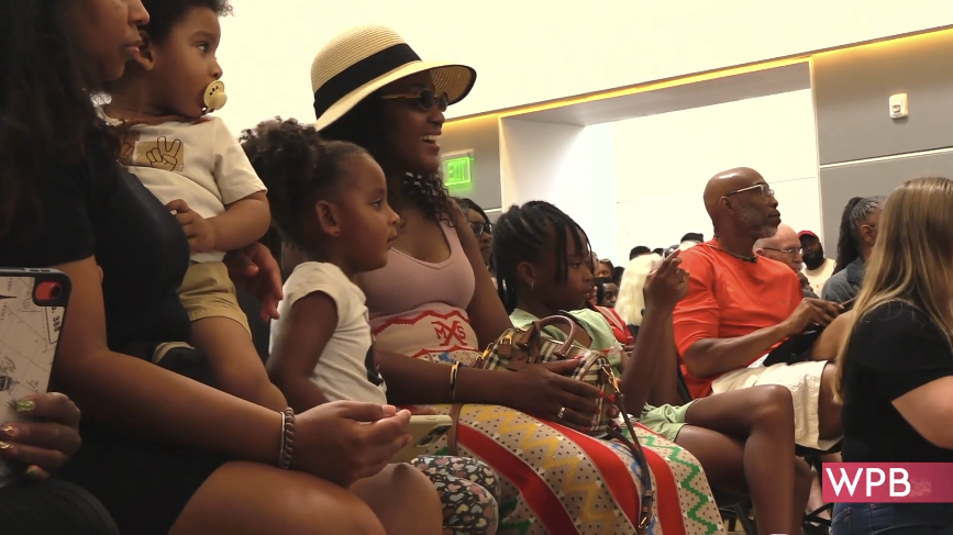 People sitting in audience smiling during Juneteenth Community Day at Norton Museum of Art 