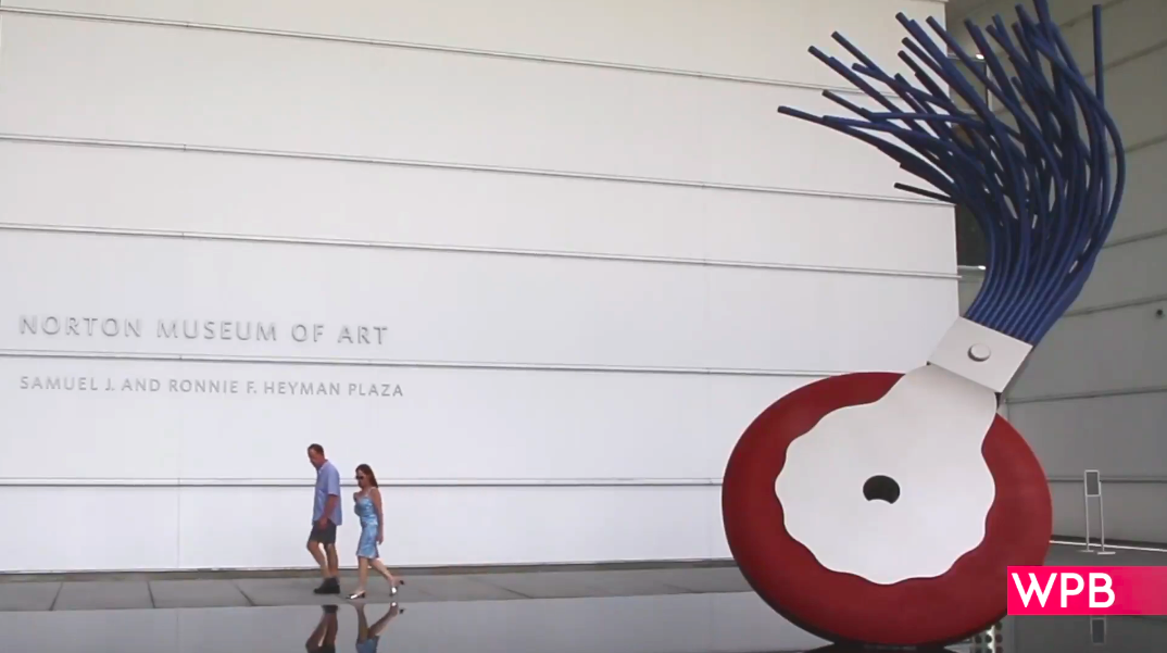Norton Museum of Art, photo of the front of the building with two people walking by