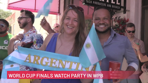 Two people smile for the camera during a World Cup Watch Party in West Palm Beach