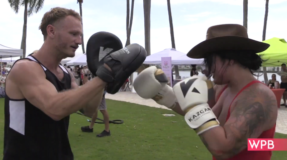 Two people sparring/boxing on the West Palm Beach Waterfront