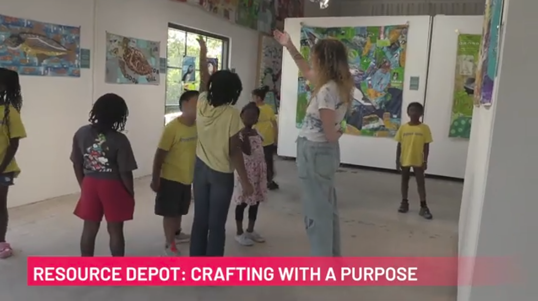 A women and children look at art on the wall. Link to WPBTV Video titled Resource Depot: Crafting with a Purpose