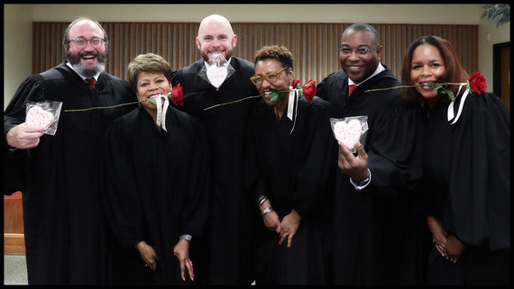 Judges celebrating with red roses and heart-shaped cookies after Valentines Day Weddings