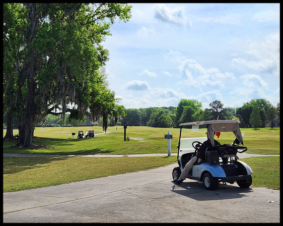 Solitary golfer waits in his cart for links to open