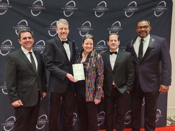 Group of people posing with an award