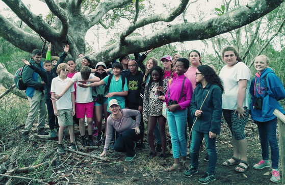 Adam Mackinnon, far left, exhibits his usual enthusiasm and humor with a school group on Sapelo.