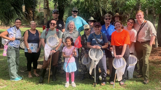 Adults, children training for bumblebee atlas pose for group picture