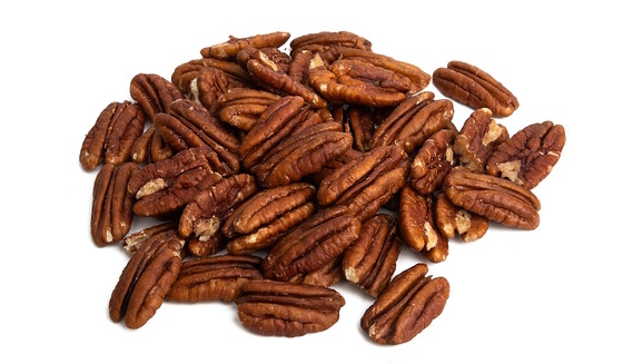 Group of golden brown pecan meats (no shells) on a white background