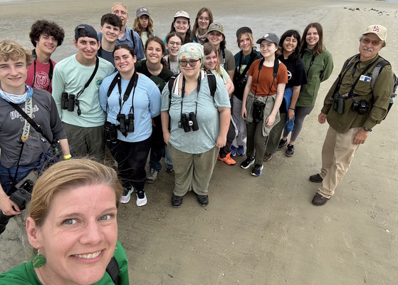 Selfie of Camp TALON group on tan-sand beach