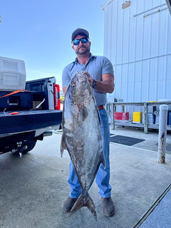 Chris A. Germano of St. Simons Island, Ga., with his record-setting Almaco Jack.