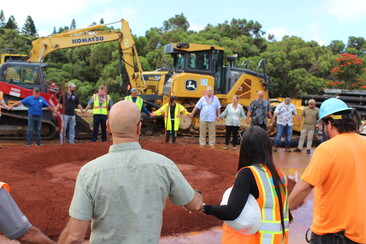 Personnel from management to field crews join hands during the Kalaheo Water Systems Improvements Project blessing