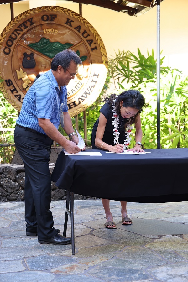 Emily Ishida signing oath of office