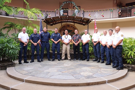 Four promotees pose with the Mayor of Kauai and FIre Admin leadership