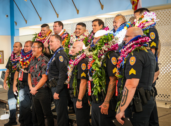 Mayor Kawakami and Chief Raybuck take photos with newly promoted officers.
