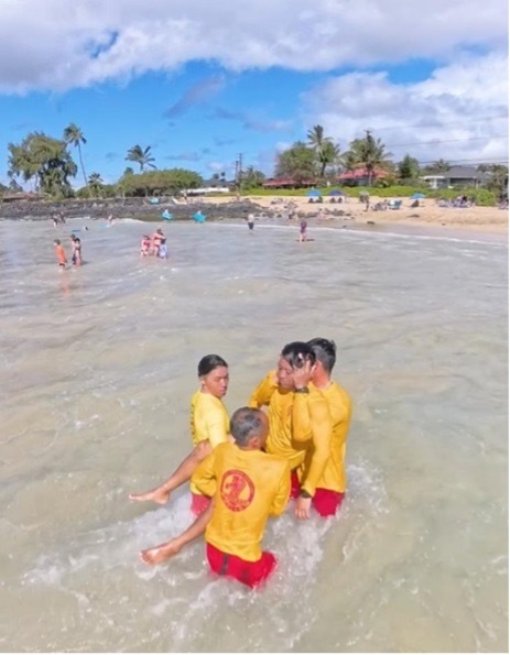 Okinawa lifeguards practicing hazardous water rescues at Po‘ipū