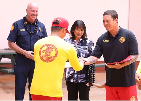 A lifeguard from Okinawa receives a certificate for completing of the inaugural Lifeguard Exchange Program