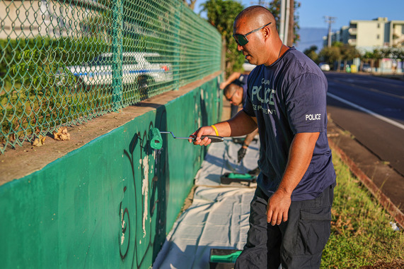 Officers painting over graffiti