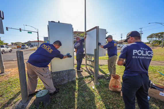 Officers cleaning up graffiti
