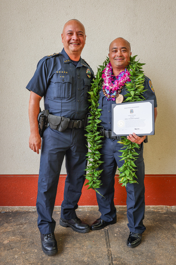 Chief Ke congratulates Officer Arnold Cayabyab on his retirement and recognition as Employee of the Month