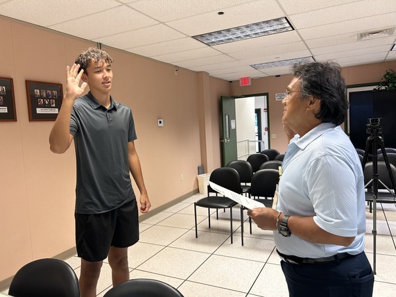 Swede Sandblom (left), a senior at Waimea High School, being sworn in by Eddie Topenio.