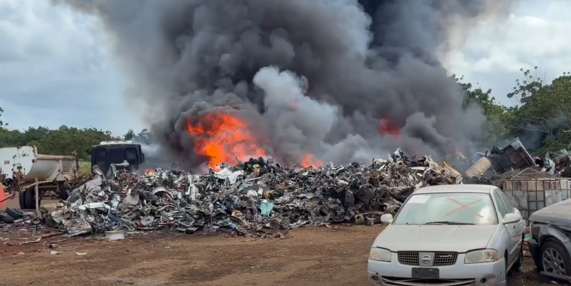 Scrap metal and debris engulfed in flames. ###