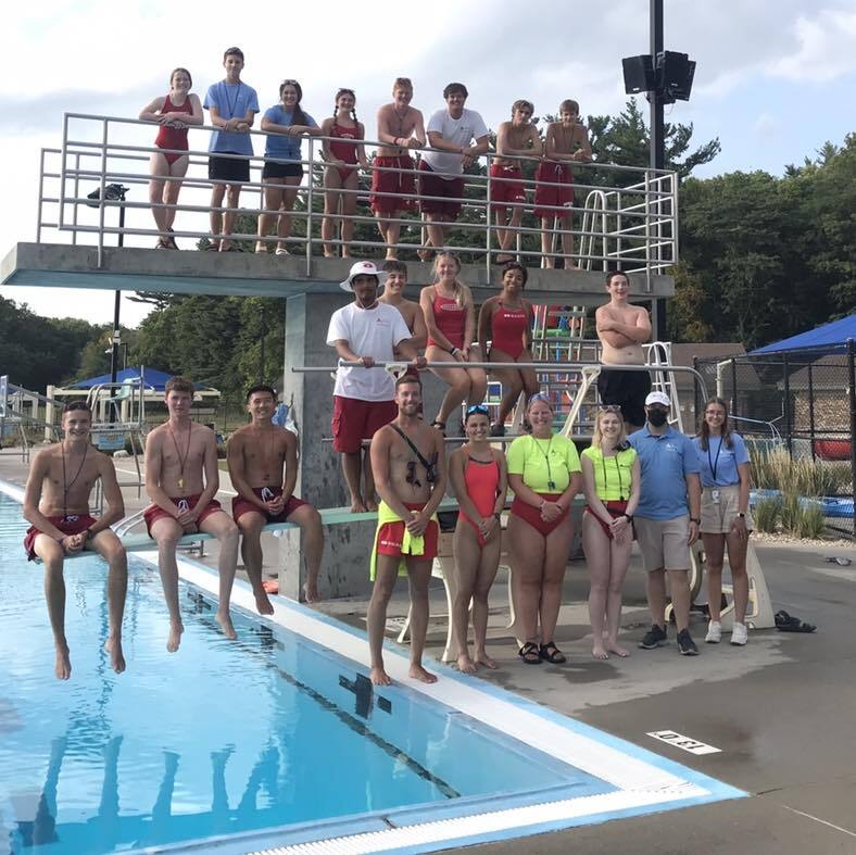 Furman staff standing around the pool and diving board