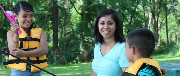 A mom fishing with her young son and daughter