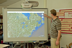 Teacher using white board map of United States