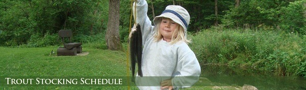 A young girl holding up a trout she caught in a northeast Iowa trout stream.