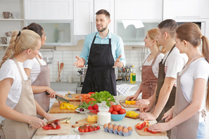 Cooks being trained by cooking teacher