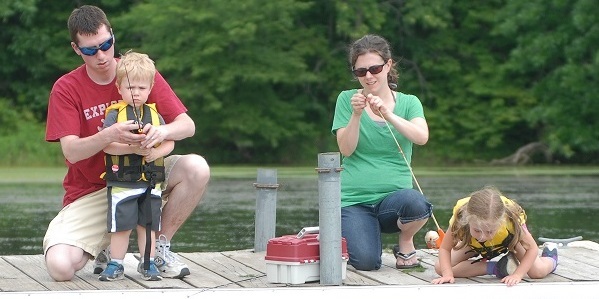 A family fishing from a dock.