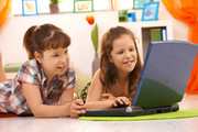 Elementary school aged girls looking at laptop