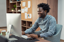 African American male working at computer