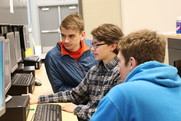 Students conferring around a computer.