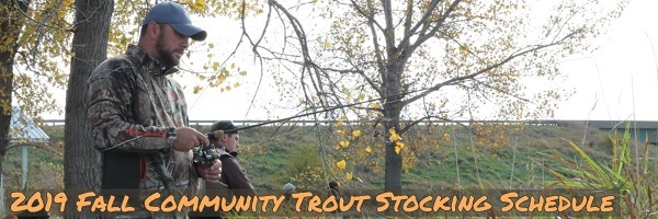 A man fishing for trout at a community trout fishing lake.