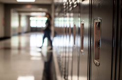 School lockers with blurred human figure in background