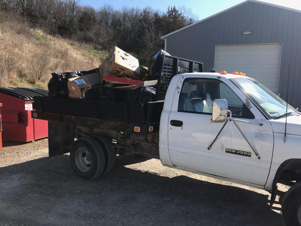 flatbed truck filled with trash bags 