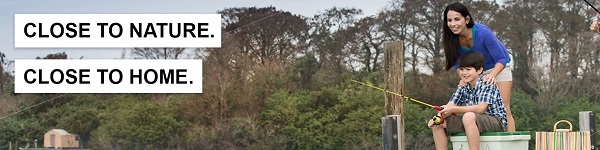 A mom and son fishing from a pier.