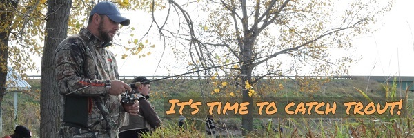 A man fishing for trout in the fall at a community fishing pond.