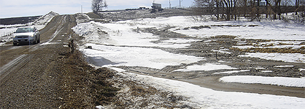 Runoff from manure application on snow-covered ground.
