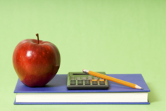 School nutrition finances, calculator, book, pencil, apple