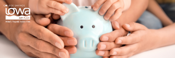 Blue piggy bank being held by a family